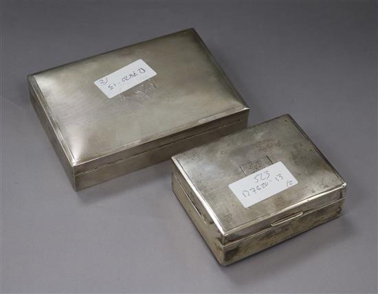 Two engine turned silver cigarette boxes, largest 16.3cm.
